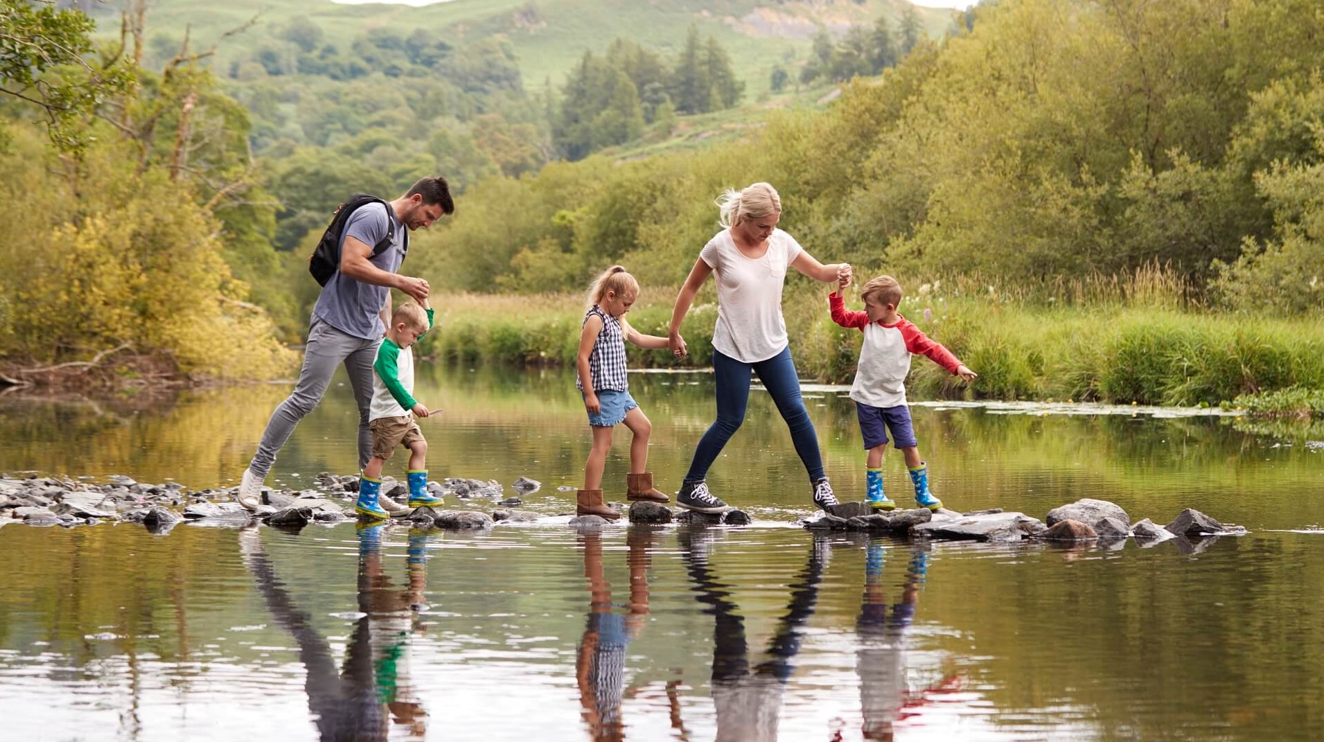 Family walking in a creek